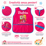 Grembiule da pittura bambina fucsia con bordo turchese, chiusura posteriore regolabile
