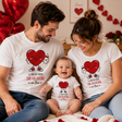 T-shirt bianche e body neonato con grafica a cuori rossi e testo “San Valentino in tre”