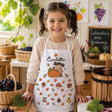 Grembiule bimba bianco con zucche e foglie autunnali, nome Carlotta